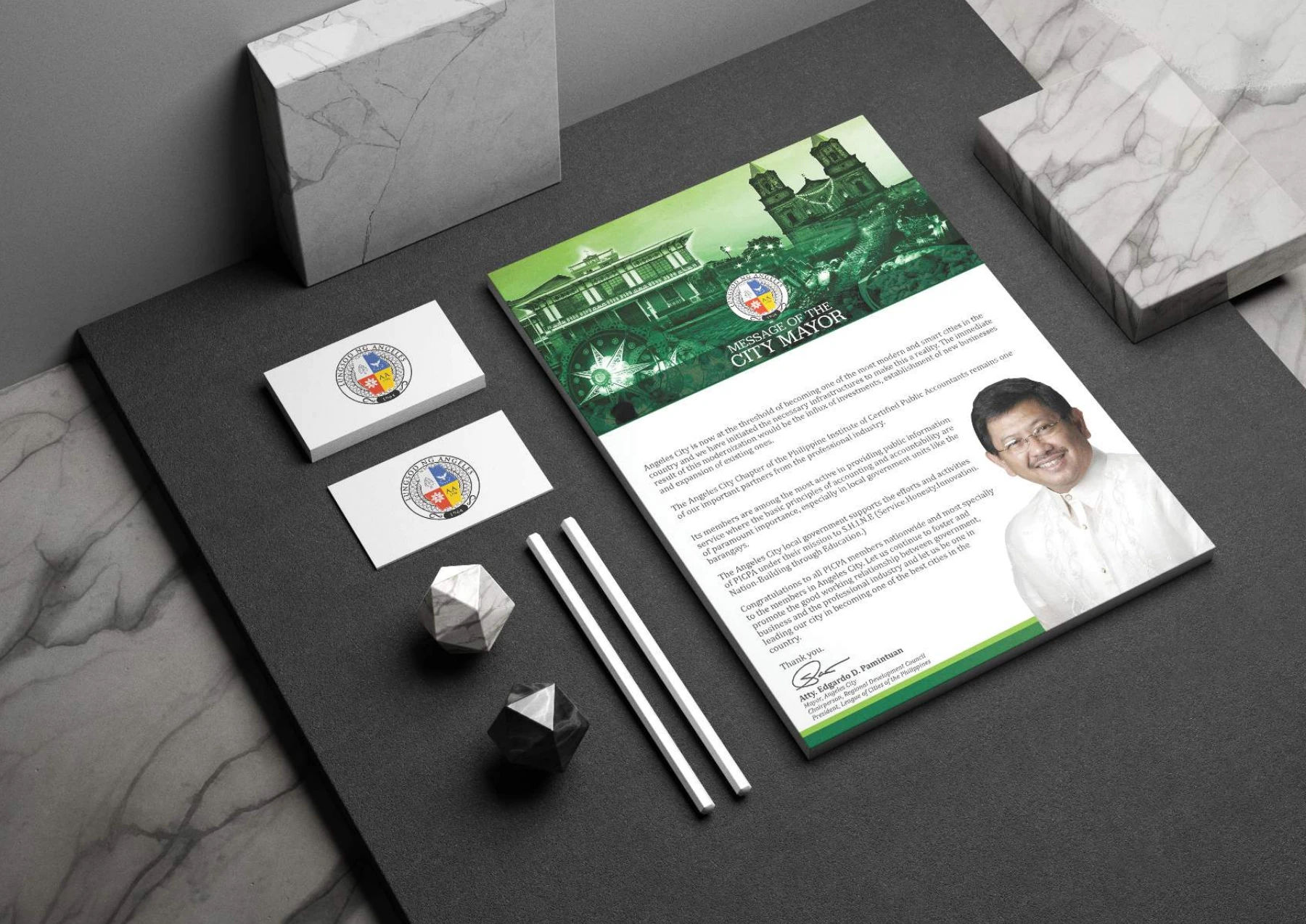 Angeles City civic stationery and printed communication presented on a desk.